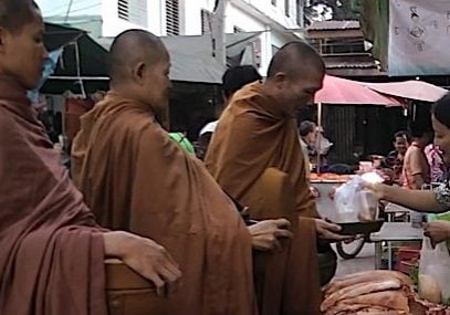 Buddha-Weekly-2Monks-Buddhist-receiving-alms-gives-opportunity-for-lay-believers-to-practice-generosity Practicing generosity creates positive karma. Here, a kind lay-Buddhist gives alms to three monks who, like the Buddha, eat only before noon and only from food given to them. Merit for good deeds is an intuitive concept in karma.