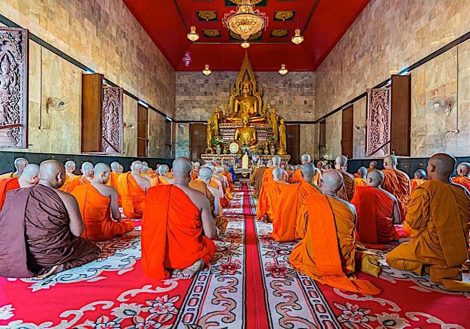 Buddha-Weekly-Buddhist monks chanting in Kanchanburi Thailand in front of golden Buddha dreamstime_xl_116332936-Buddhism Most traditions of Buddhism hold chanting of Sutras as a primary practice of great merit. Here monks are chanting in Kanchanburi Thailand in front of a golden Buddha.