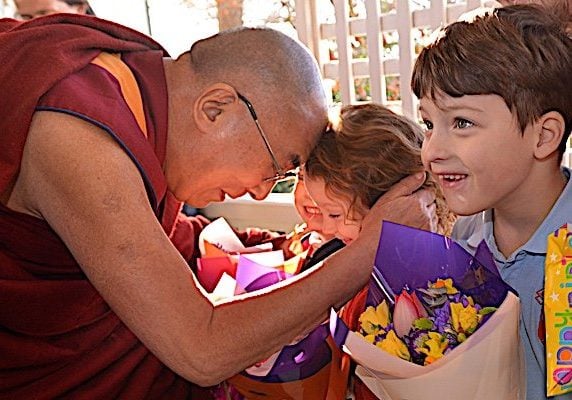 Buddha-Weekly-Dalai Lama and children-Buddhism The Dalai Lama with children. Even though the Dalai Lama is very science-oriented, his priority clearly is Dharma, the teachings, and most especially compassion and love for all beings.