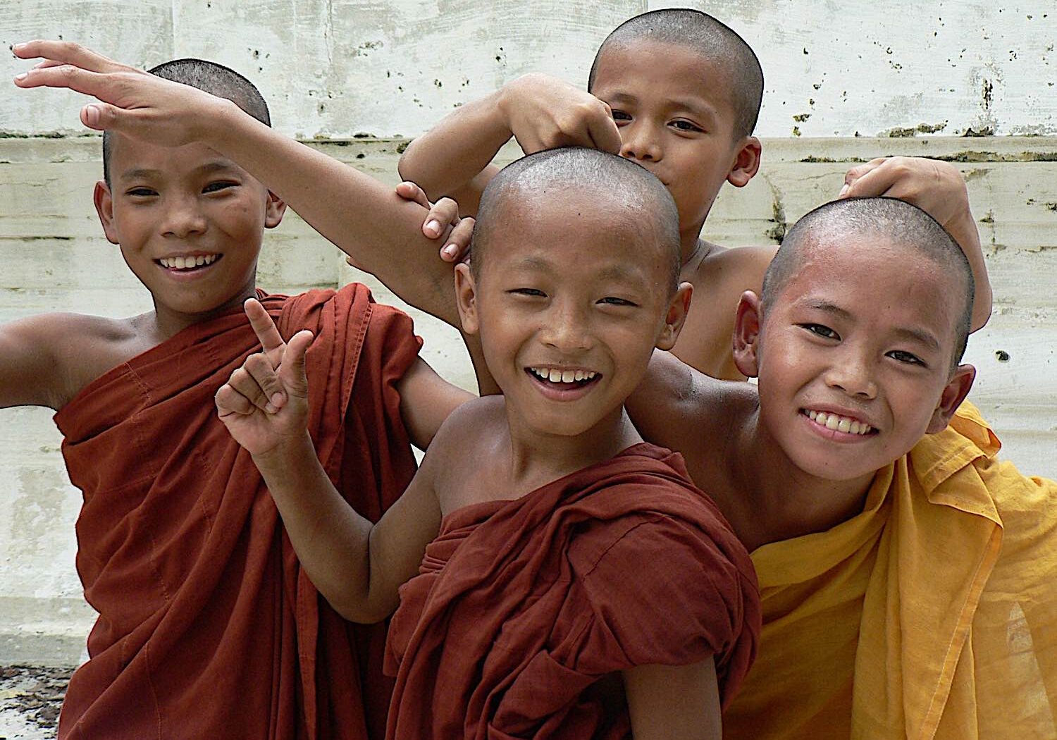 Buddha-Weekly-Four happy monk Myanmar Buddhist novices dreamstime_l_182369874-Buddhism Four happy novice Buddhist monks.