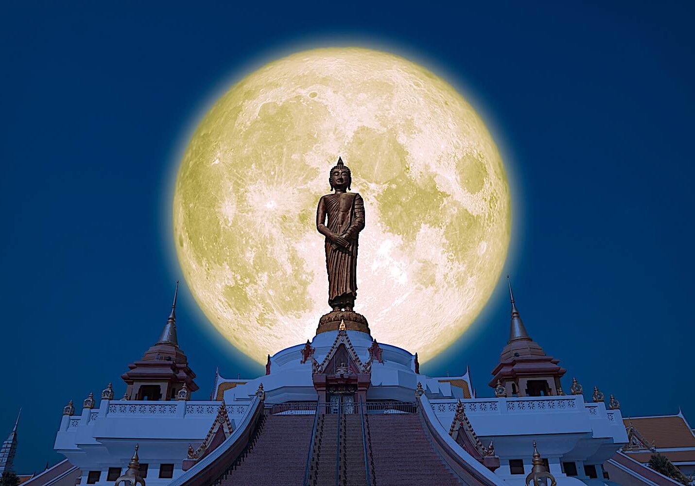 Buddha-Weekly-Full moon and the Temple dreamstime_l_188408666-Buddhism Buddha statue against a full moon.