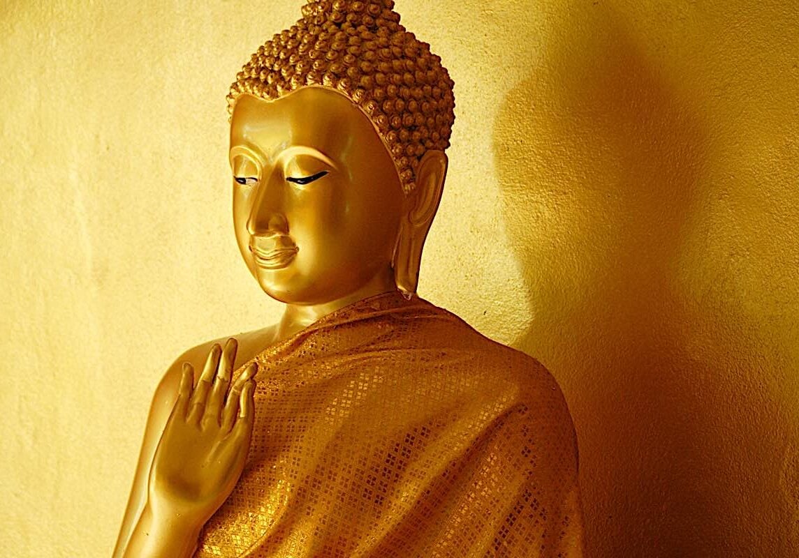 Buddha statue, with his hand in the mudra of teaching.
